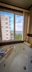Luxury bathroom with jacuzzi tub and ocean view window in PH Las Olas at Vista Mar Panama