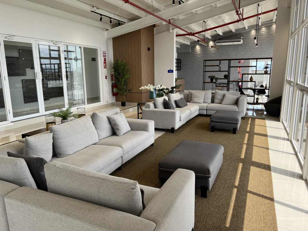 Bright living area with sliding doors opening to balcony in PH Venice Place Condado del Rey