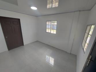 Open hallway and living space with arched wall opening in house La Chorrera Panama