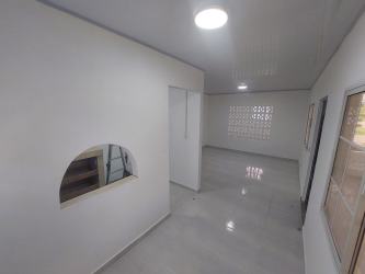 Bright hallway with glass block window and arched cutouts La Chorrera house