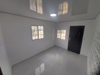 Minimalist interior living area with tiled floor and white walls La Chorrera Panama