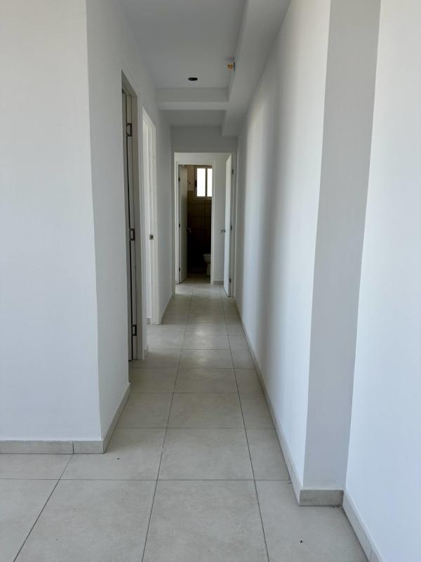 Bright living room with large sliding doors access to balcony floor tile PH Mystic Valley El Crisol Panama City