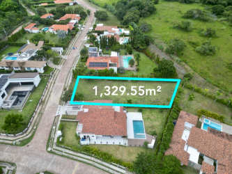 Neighborhood aerial showing beach lot, houses, green areas in Punta Barco Village Panama