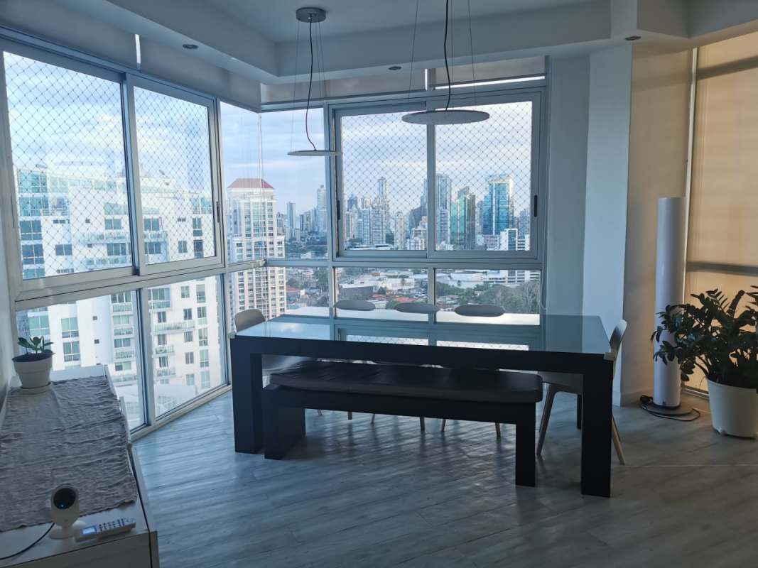 Modern dining space with large windows and city skyline at PH Park View San Francisco