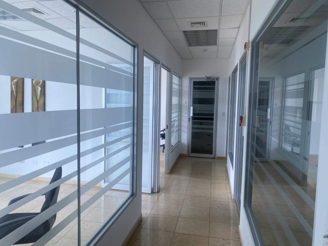 Glass walled corridor with private offices and frosted panels Torre Global Bank Panama