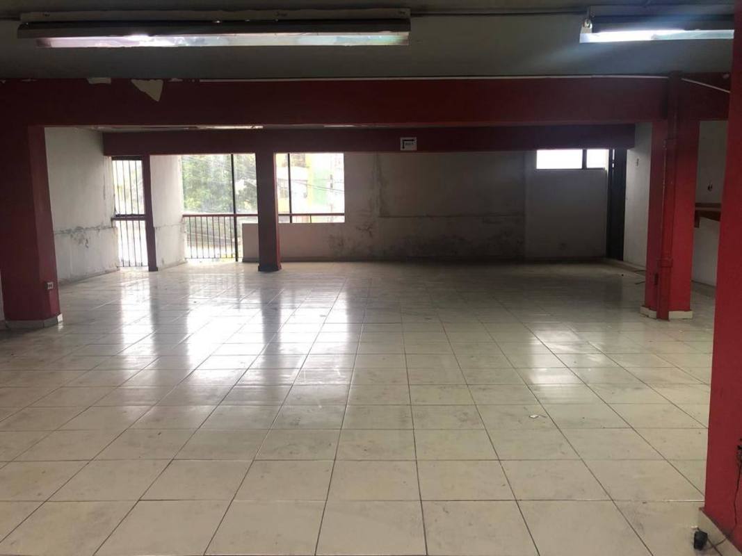 Empty tiled open commercial space with barred windows at Edificio Casa Gala Panama