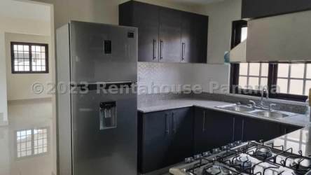 Kitchen equipped with refrigerator, stove and ample cabinetry at Sunset Hills Costa Verde house rental Panama