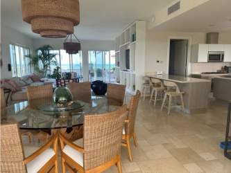 Contemporary kitchen with island, granite counters and appliances at Puntarenas Penthouse Buenaventura