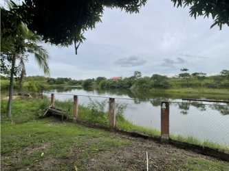Fenced backyard overlooking Lago Mar lake with open lush greenspace Panama