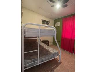 Bedroom with bunk bed, AC unit, ceiling fan, tiled floor at Lago Mar San Carlos