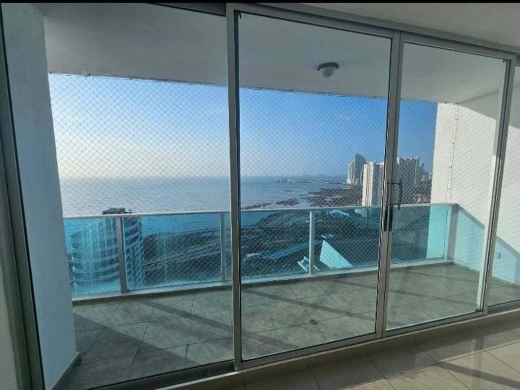 Apartment living room opening to oceanfront balcony with skyline view PH Cabo Marzo Coco del Mar Panama