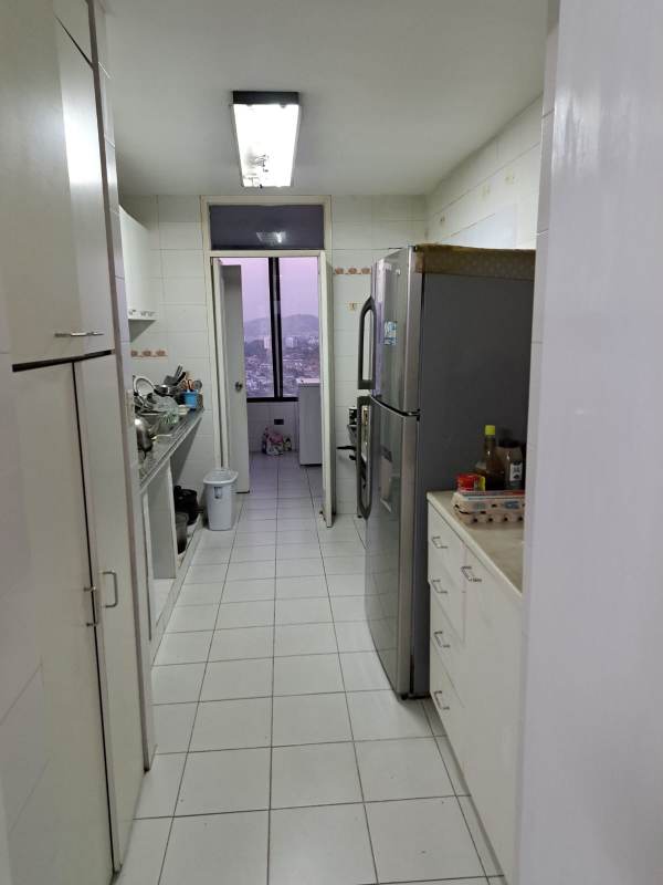 Simple galley kitchen with window city view white tiles at PH Pacific Hills Panama City