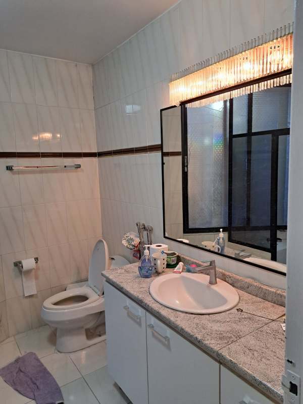 Bathroom with granite countertop, large mirror, tiled walls natural lighting PH Pacific Hills Panama