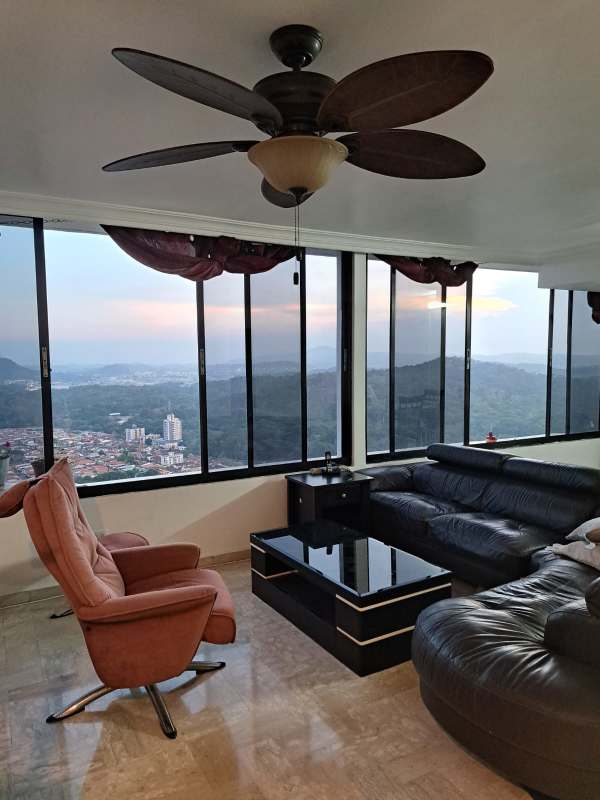 Bright open living space with marble floors panoramic windows city mountain view Pacific Hills Panama
