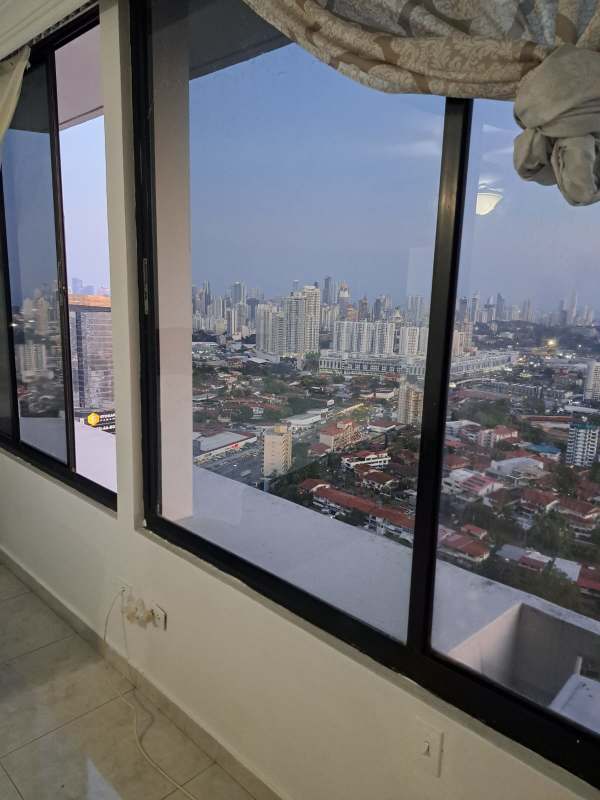 Modern apartment living room with mountain skyline views floor-to-ceiling windows marble floors Pacific Hills Panama