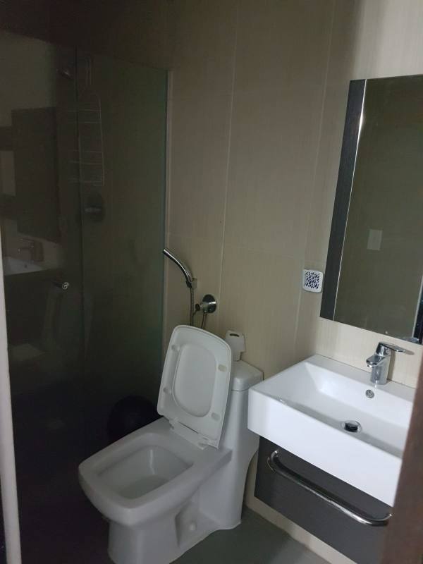 Laundry area with washer dryer hookup beside kitchen in PH Colores de Bella Vista Panama