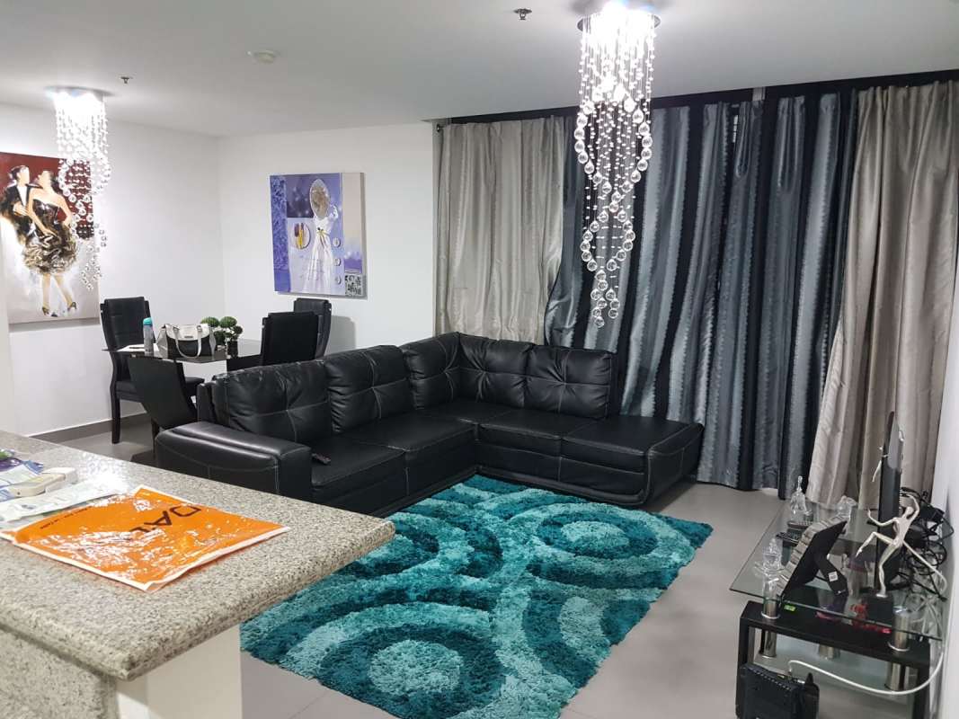 Modern dining room with glass table, leather chairs, and panoramic city views in PH Colores de Bella Vista Panama City