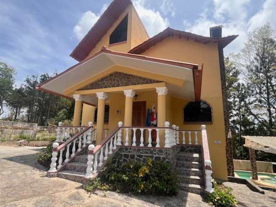 Home exterior with private pool, jacuzzi, pergola, waterfall feature, and stone walls in Altos de Cerro Azul Panama