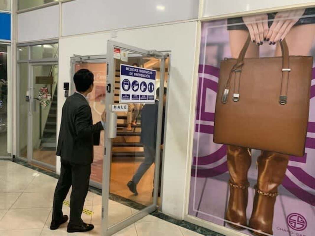 Glass door entrance and large advertisement signage inside Plaza Paitilla Panama
