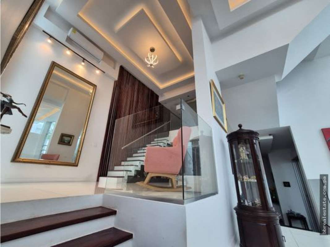 Luxury entry with modern floating staircase, glass railing in Altos del Golf residence Panama