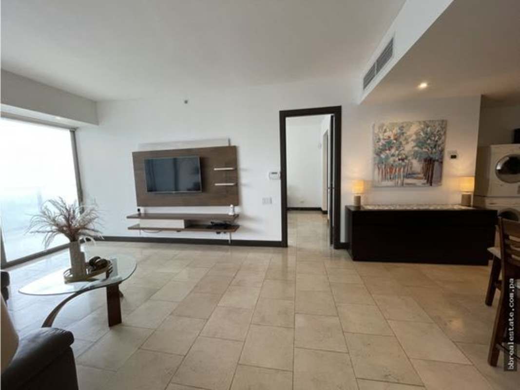 Open concept living and dining space with large windows and ocean views in Trump JW Marriott Panama