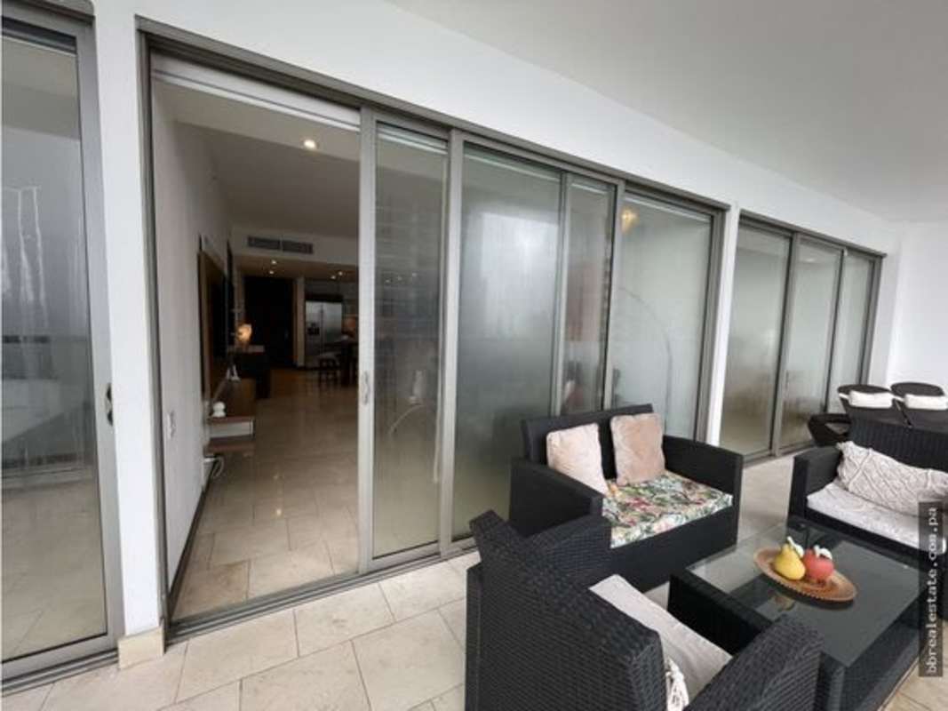 Modern balcony with seating area overlooking Pacific Ocean and city skyline at Punta Pacifica