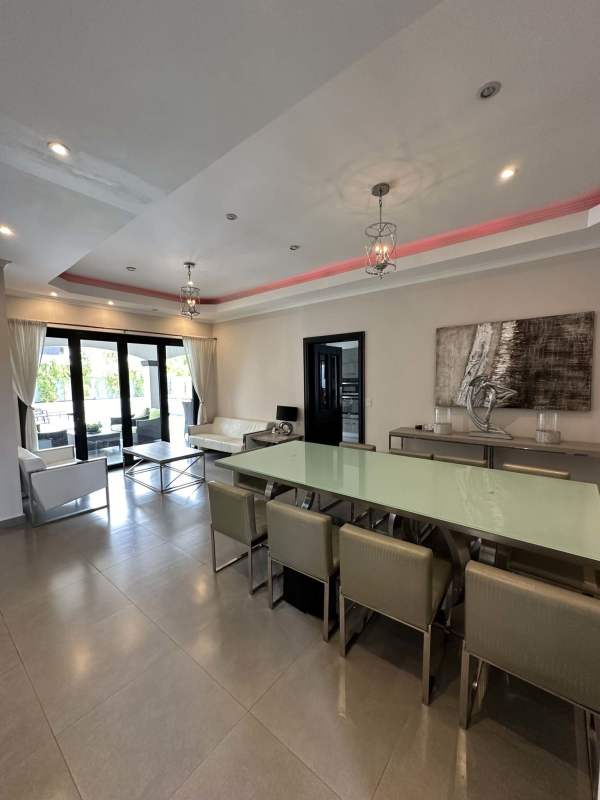 Large modern living room with sectional sofa, entertainment unit and luxury decor in Las Magnolias Costa del Este Panama