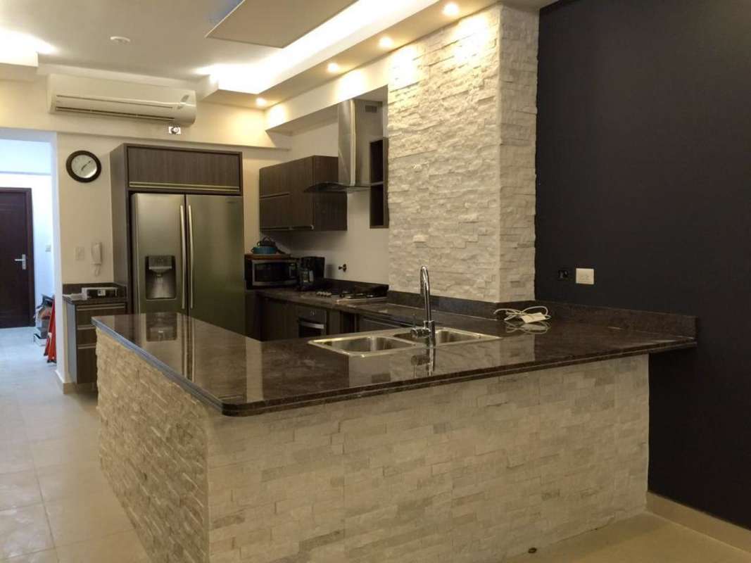 Modern kitchen with island, stone accents, granite countertops in PH Rivage Avenida Balboa