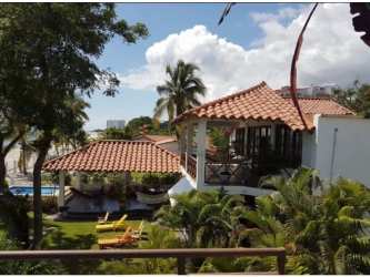 Villa exterior terracotta roof balcony tropical garden pool beachfront Rio Hato Panama