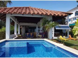 Mediterranean villa pool covered patio terracotta roof tropical plants beachfront Panama