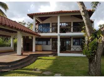 Covered patio with tropical landscaping pool terracotta roof villa Panama beach