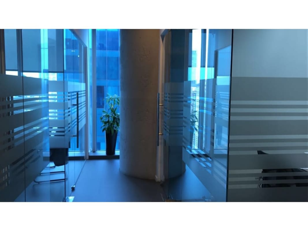 Modern hallway with floor-to-ceiling windows city view in Oceania Business Plaza