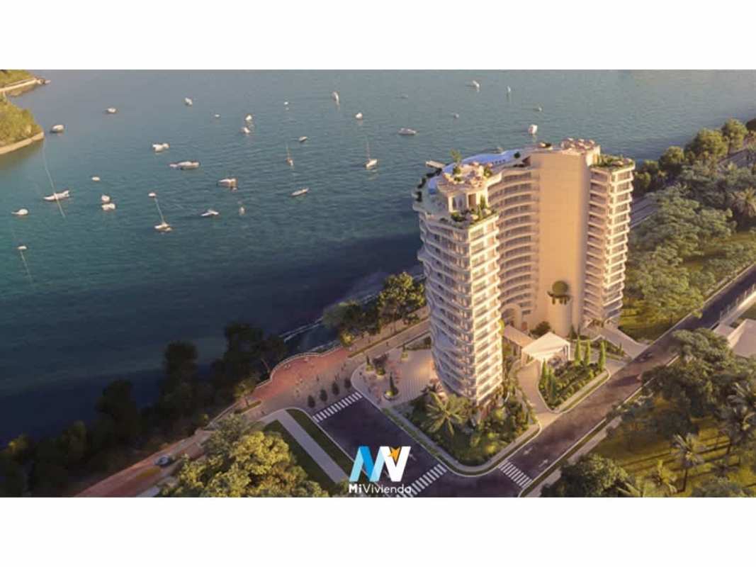 Aerial photo modern high-rise waterfront condo tower alongside marina and city entrance Panama