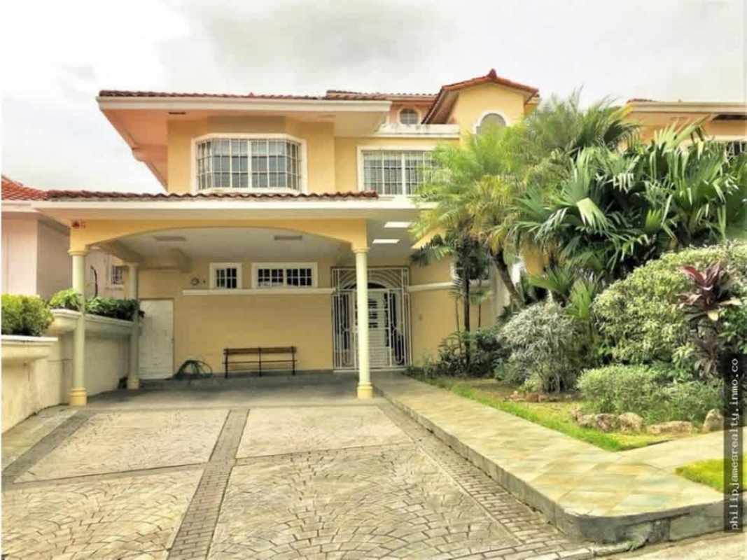 Large living room Betania duplex with beige sofas, artwork and tiled floor El Avance community Panama City