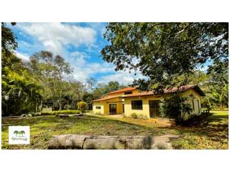 Yellow ranch style single story countryside house with trees and garden Capira Panama