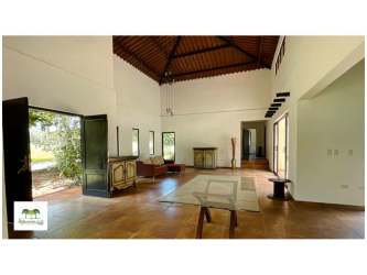Kitchen with island, wood cabinetry and granite countertops in PH Arboleda de Santa Cruz Capira