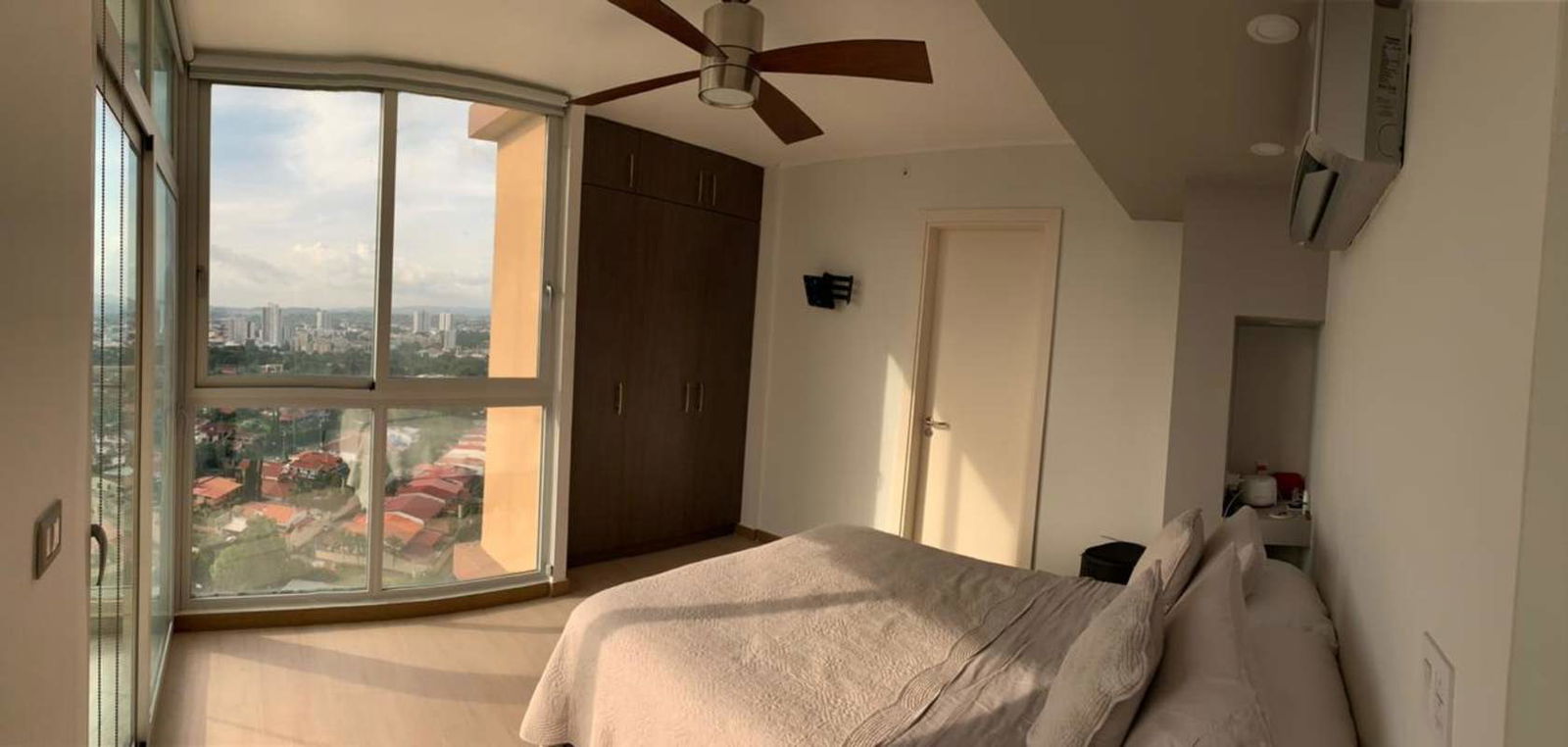 Bedroom with large window, balcony door, city views PH Quartier del Mar Panama