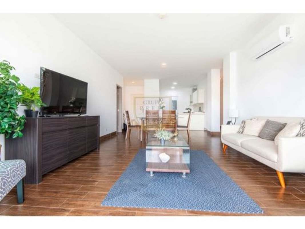Open plan living dining area with wooden floors and natural light Costamare Panama