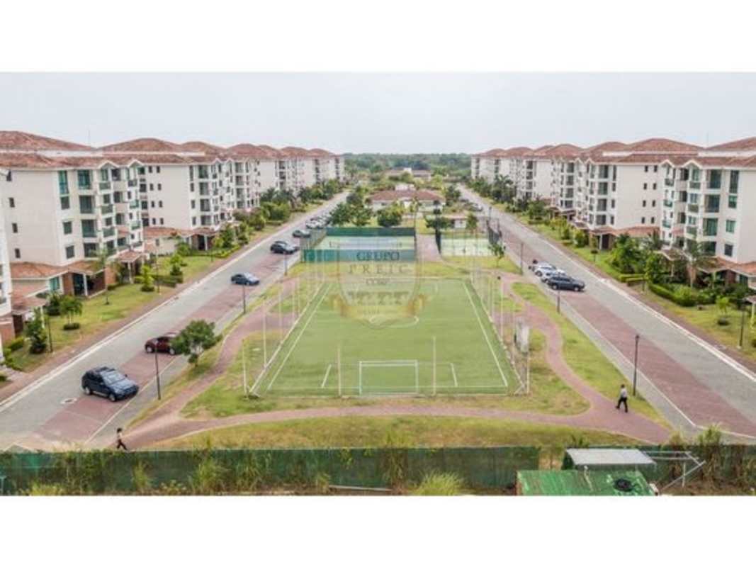 Aerial image showing multiple apartment buildings with soccer field, tennis courts and gardens in Costamare Costa Sur Panama