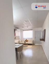 Bright bedroom with pink accents, single bed, and study desk at Mystic City Panama