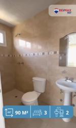 Bathroom with tiled walls, walk-in shower, pedestal sink at Mystic City La Chorrera Panama