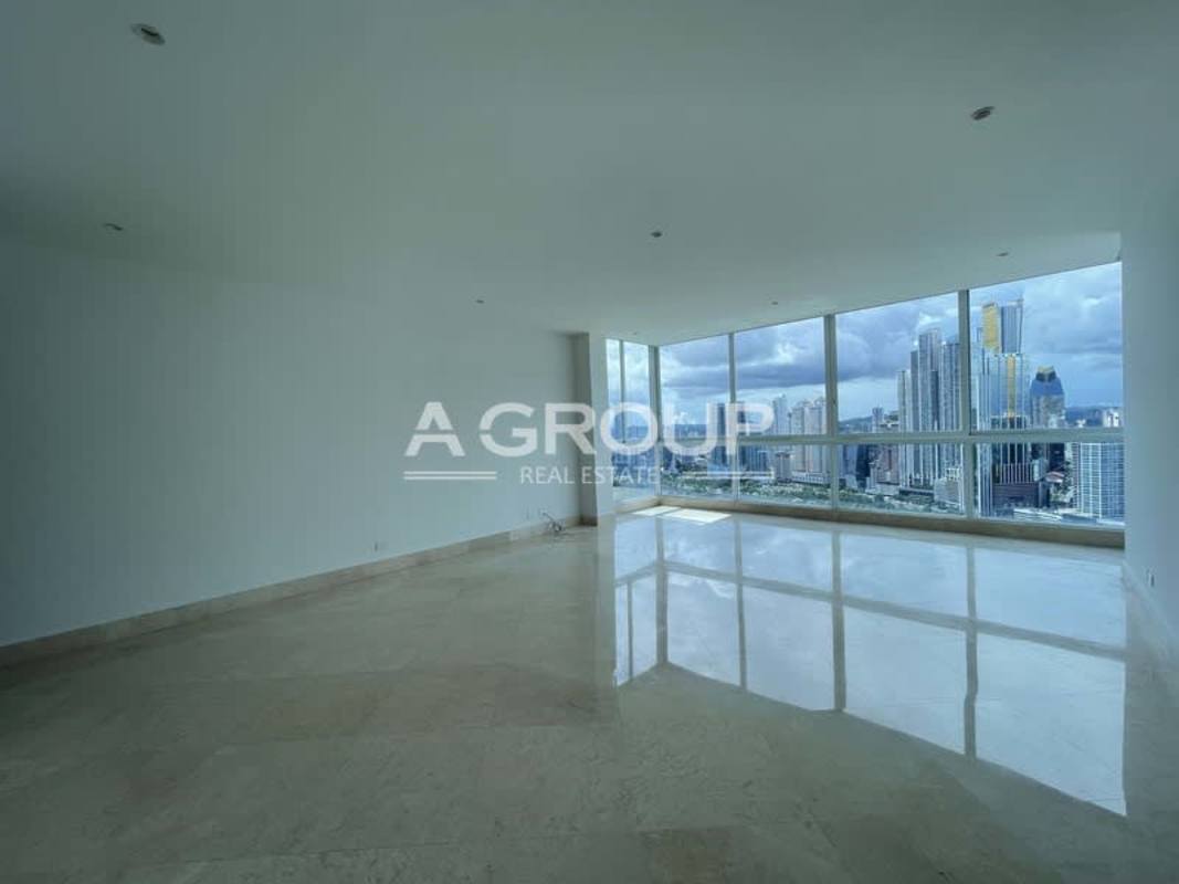 Bright living room with panoramic windows, marble floors and breathtaking views at The Point tower