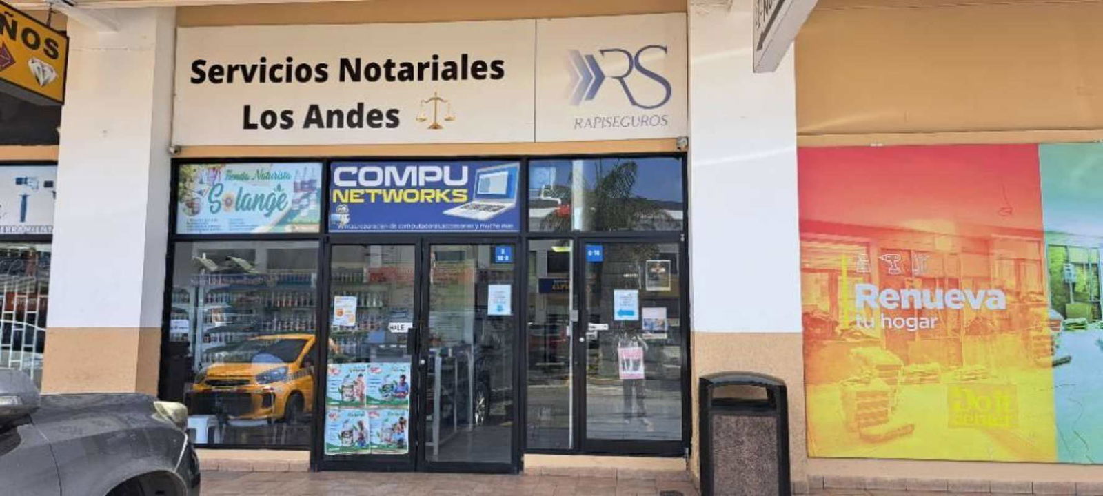 Strip mall storefronts signage at Centro Comercial Los Andes Panama City retail plaza view