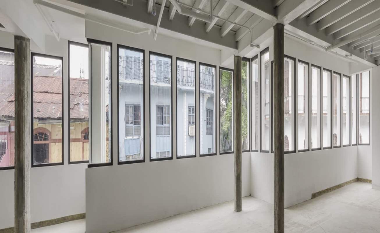 Open loft-style commercial unit with large windows and exposed beams Casco Viejo San Felipe Panama City