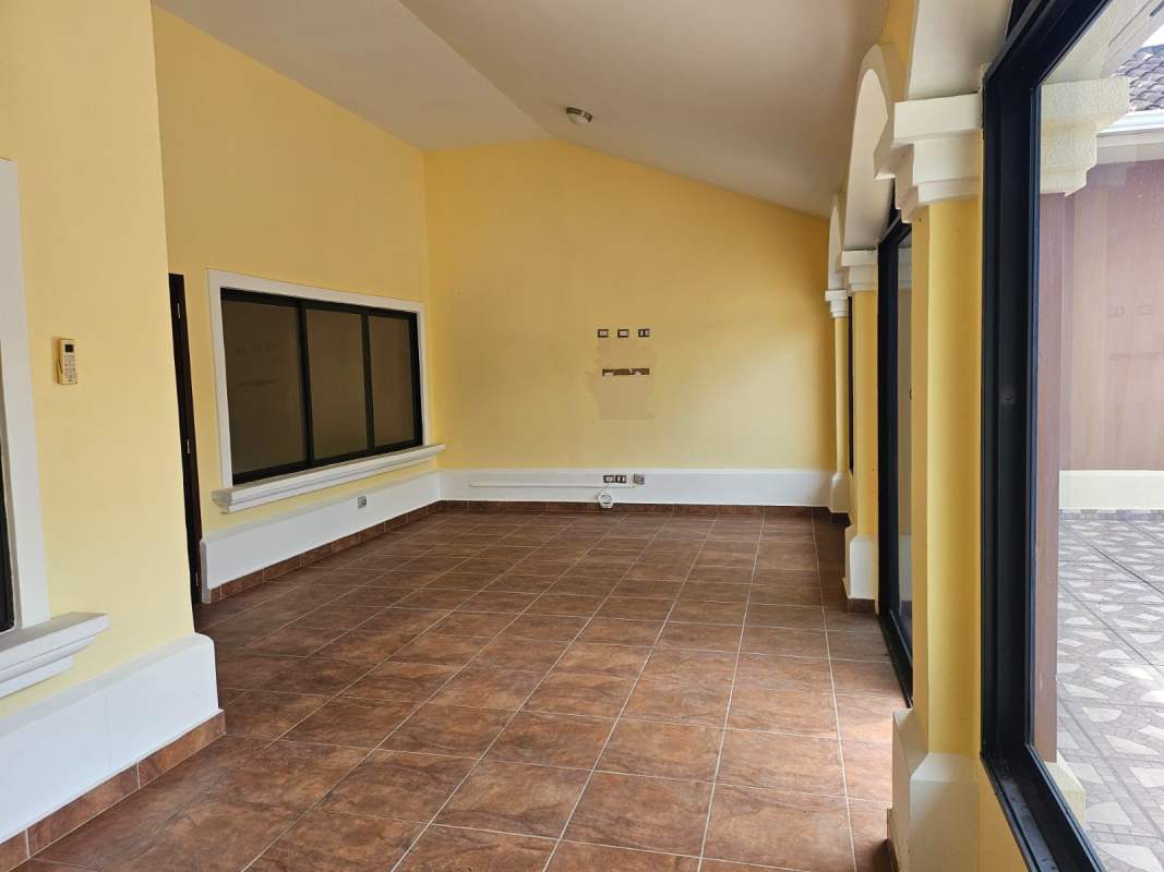 Kitchen with granite countertops, island and dark cabinetry in Sunset Coast Costa Sur