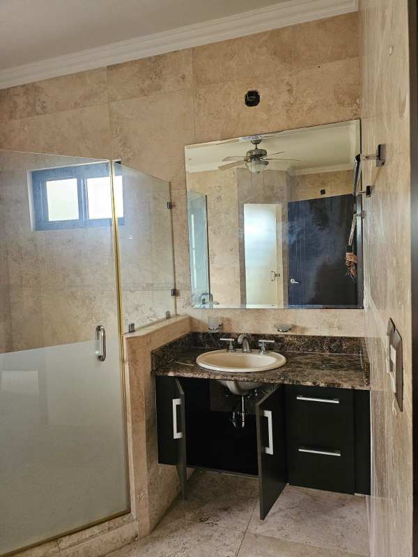 Interior courtyard with terracotta tiled roof arched windows and garden in Costa Sur Panama