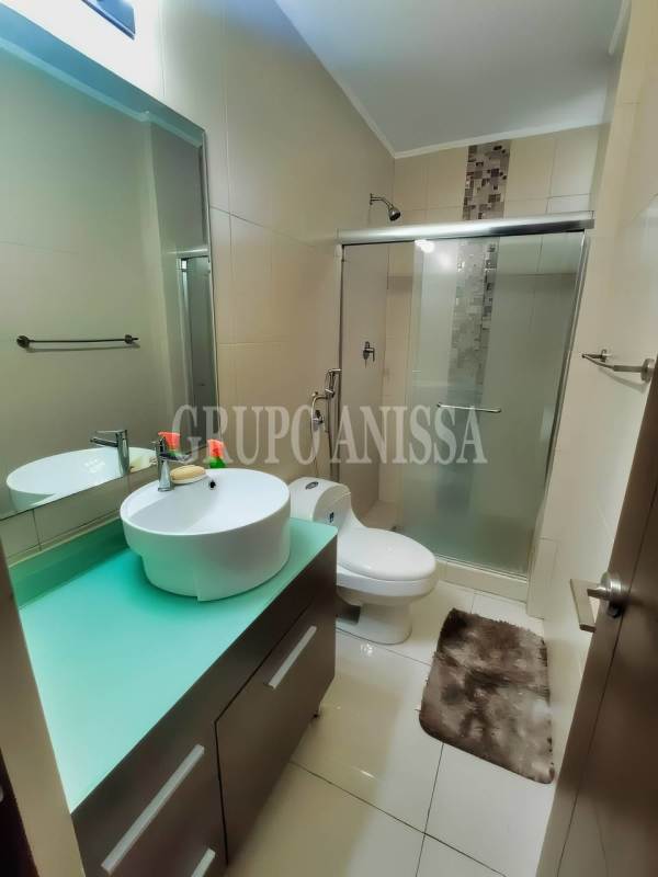 Secondary furnished bedroom with closet and city skyline view in PH Midrise San Francisco