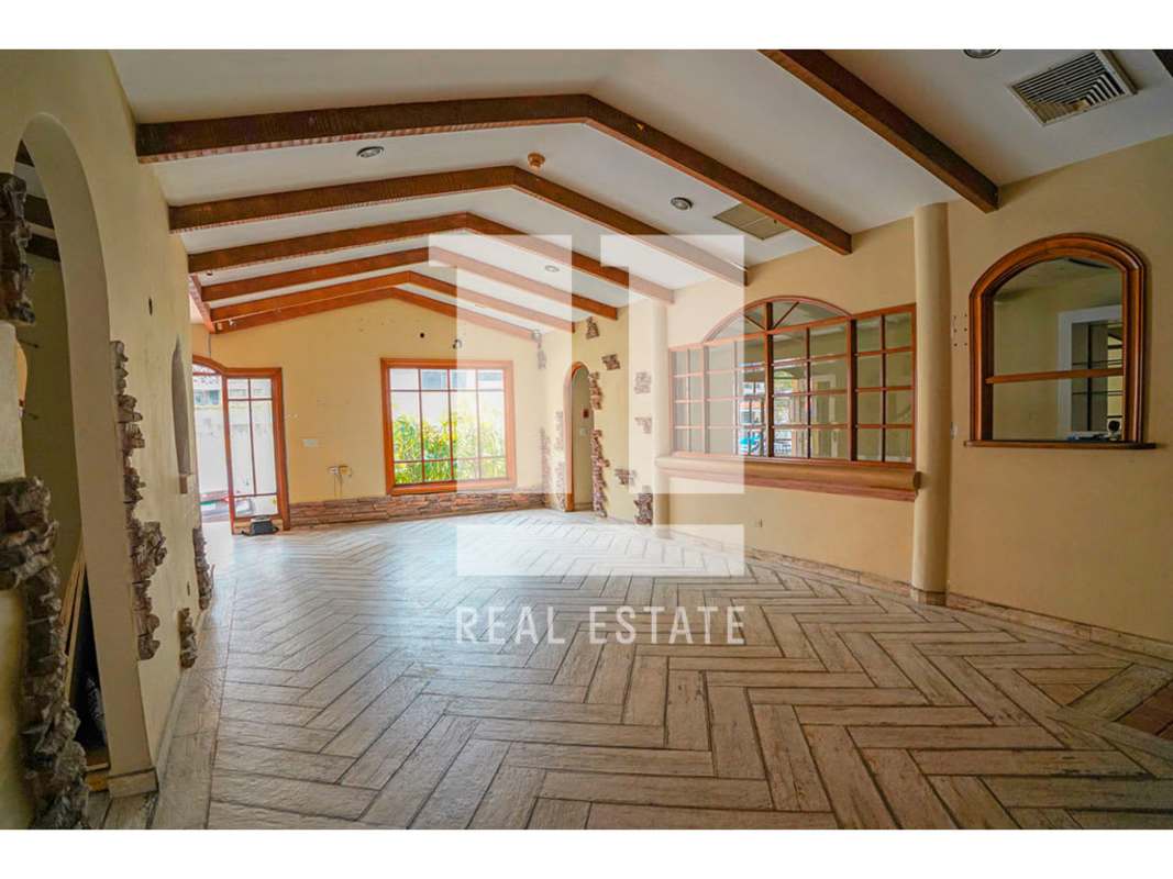 Rustic commercial interior with exposed beams, bright tiled floors, arches in Bella Vista Panama