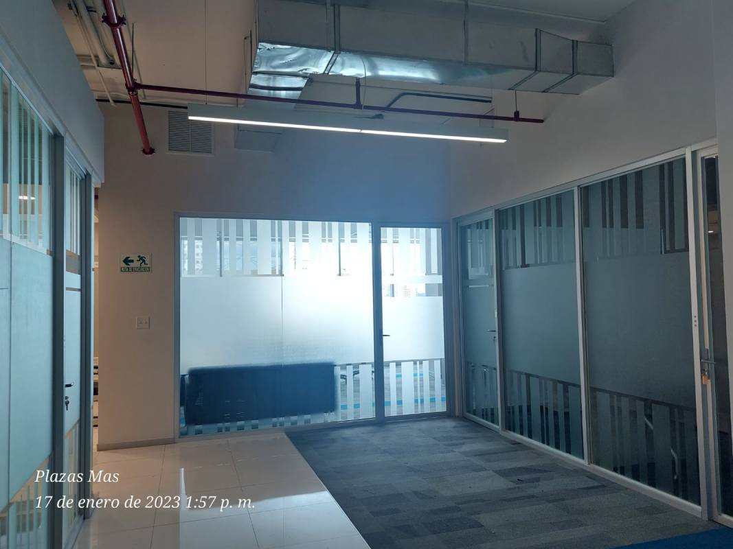 Office corridor with glass dividers and exposed ceiling in PH Tula commercial office tower Panama