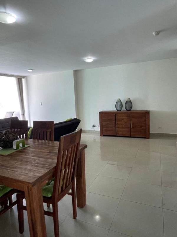Modern dining area with wooden furniture, tile floor, split AC near open living area in Costa del Este Panama